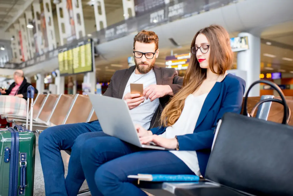 Couple using Wi-Fi at airport